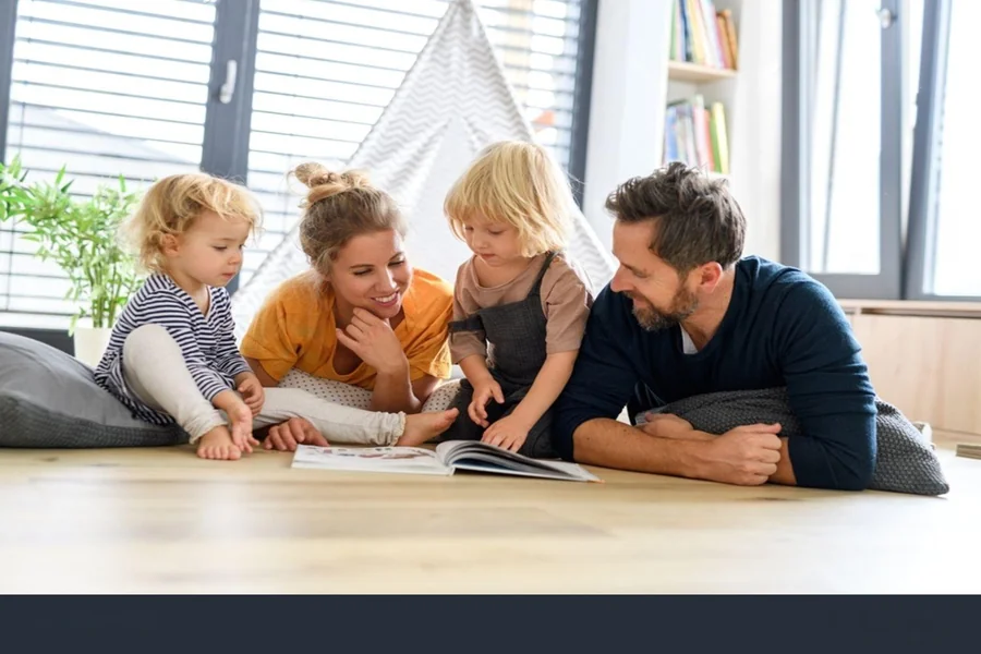 A family looking at a family tree in a book, and wonderin